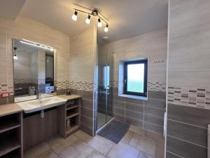 a bathroom with a shower and a sink and a mirror at Gîte Isle-et-Bardais, 3 pièces, 6 personnes - FR-1-489-331 in Isle-et-Bardais