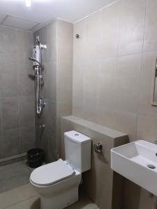 a bathroom with a toilet and a sink at Nasuha Homestay in Sandakan