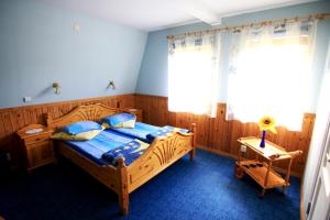 a bedroom with a wooden bed and a window at Pie Maijas in Saulkrasti