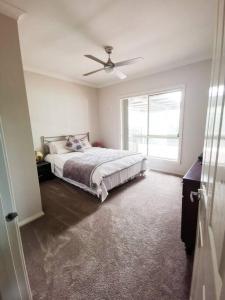 a bedroom with a bed and a ceiling fan at wonderwander -the whole farm house in Ravensfield