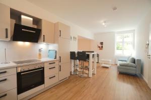 a kitchen with a sink and a stove top oven at Apartment am Hafen in Schleswig