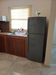 a kitchen with a black refrigerator in a kitchen at Casa Sendero in Los Mochis