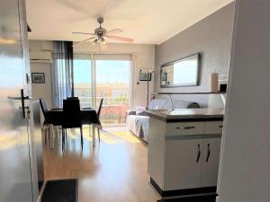 eine Küche und ein Wohnzimmer mit einem Tisch und einem Bett in der Unterkunft Appartement Port-la-Nouvelle, 2 pièces, 4 personnes - FR-1-229C-83 in Port-la-Nouvelle