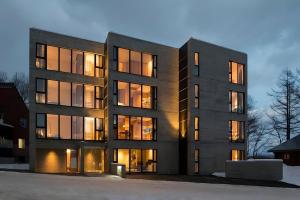a largeartment building with its lights on at Kozue in Kutchan