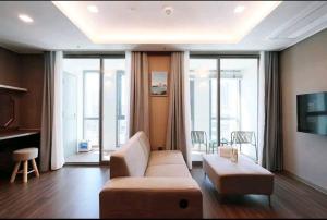 a living room with a couch and a table at RUNA Stay HAEUNDAE in Busan