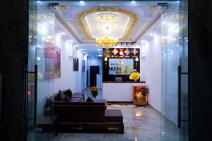 a living room with a couch and a chandelier at Huong Mai Hotel in Da Lat