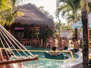 a group of people in the swimming pool at a resort at Clandestino Hostel Canggu in Canggu