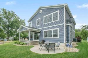 a house with a table and chairs in the yard at The Heron House-On The Lake! in Wolcottville