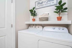 a white laundry room with a washer and dryer at The Heron House-On The Lake! in Wolcottville