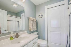 a bathroom with a sink and a toilet and a mirror at The Heron House-On The Lake! in Wolcottville +27 photos