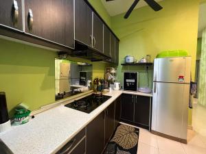 a kitchen with a stainless steel refrigerator and cabinets at RUMAH INDAH by IMPIAN HOMESTAY KLIA-SALAK TINGGI-NILAI in Sepang