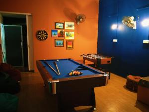 a room with a pool table and a table at Dorm Master in Kampung Padang Masirat