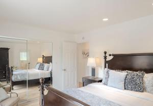 a bedroom with two beds and a mirror at 3896 Gather and Rest home in Del Rey Oaks