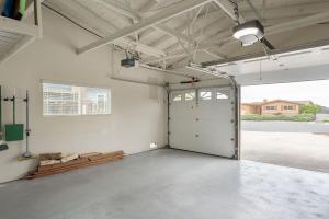 an empty garage with a garage door and a window at 3896 Gather and Rest home in Del Rey Oaks
