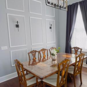 a dining room with a wooden table and chairs at The Historic Bourbon Suit walk to French Quarter in New Orleans