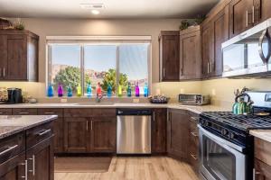 a kitchen with wooden cabinets and a large window at My Husband Wishes he could Stay Here #14 home in Santa Clara