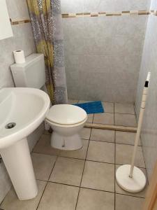 a bathroom with a toilet and a sink at Monolocale economy a 10m dal mare in Torre Mozza
