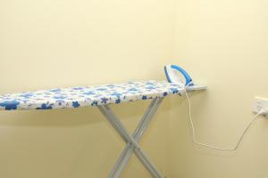 a shelf with blue and white flowers on it at Tropical Plaza Apt in Nadi