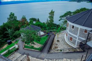 an aerial view of a house next to the water at KIGUFI HILL, Agape Resort & Kivu Edge in Gisenyi