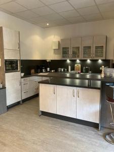 a large kitchen with stainless steel counter tops and appliances at Haus Brandenburg in Stechlin