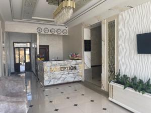 a lobby with a reception desk in a building at Art Angren Hotel in (( Sotsgorod ))