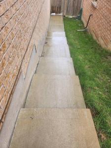 a concrete sidewalk next to a brick wall at Adorable 2-Bedoom walkout basement Apartment in Milton