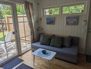 a living room with a couch and a table at Cute little cottage in Höllviken in Höllviken