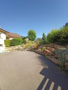 a driveway of a house with a stone wall at Mayeux in Nances