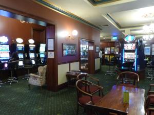 a casino with tables and chairs and slot machines at Naracoorte Hotel Motel in Naracoorte