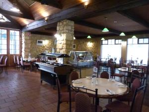 a restaurant with tables and chairs and a piano at Naracoorte Hotel Motel in Naracoorte