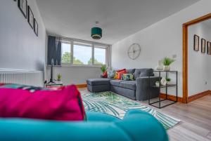 a living room with a couch and a table at Abbey Court - 2 Bedroom Apartment, Parking, CVT, JLR in Coventry