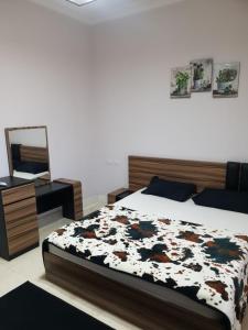 Schlafzimmer mit einem Bett, einer Kommode und einem Spiegel in der Unterkunft Tawaya sahl hashesh in Hurghada