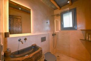 a bathroom with a tub and a toilet and a mirror at Celini villa Tinos in Krokos +85 photos