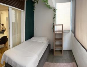 a small bedroom with a bed and a shelf at Apartment By The Center in Zadar