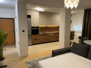 a living room with a couch and a kitchen at Apartment By The Center in Zadar