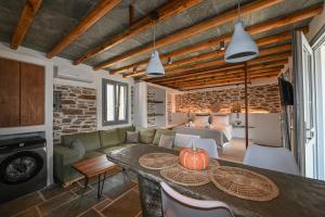 a living room with a table and a couch at Celini villa Tinos in Krokos