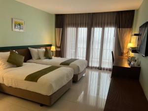 Ένα ή περισσότερα κρεβάτια σε δωμάτιο στο Siam Triangle Hotel Chiang Sean