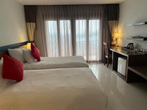 Ένα ή περισσότερα κρεβάτια σε δωμάτιο στο Siam Triangle Hotel Chiang Sean