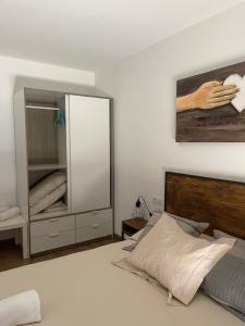 1 dormitorio con espejo grande y cama en Piso Victoria, en Guardiola de Berguedà