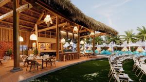 a resort with chairs and tables and a restaurant at MUINE SUN & SEA BEACH ( BOUTIQUE RESORT & GLAMPING) in Mui Ne