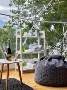 a room with a table and a bed and a bottle of wine at Elia Glamping in Stepantsminda