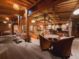 a large room with tables and chairs in a building at Ayu Dira Heritage House in Ubud