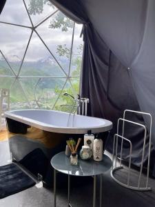 a bathroom with a tub in a tent at Elia Glamping in Stepantsminda