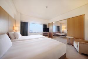 a hotel room with two beds and a television at ANA Crowne Plaza Kobe by IHG in Kobe +277 photos