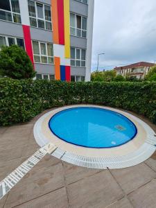 a swimming pool in front of a building at Selin's apartment with pool view in Antalya