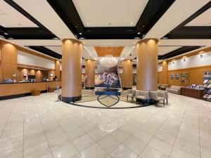 a lobby of a hotel with chairs and a reception desk at Kanku Izumiotsu Washington Hotel in Izumiotsu