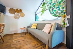 a living room with a couch and a window at Boho House 3 in camp Terme Catez in Čatež ob Savi