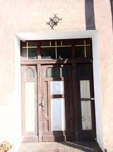 a wooden door on a building with windows at Velo Dahme - Appartement in historic building in Dahme