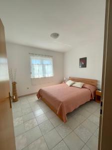 ein Schlafzimmer mit einem Bett und einem Fenster in der Unterkunft Apartments Antea in Rogoznica