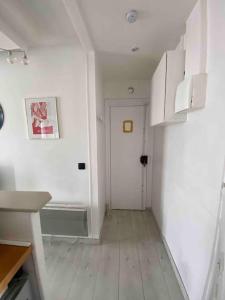 a white room with a hallway with a white door at Appartement studio proche Paris 14, Paris 15 in Malakoff